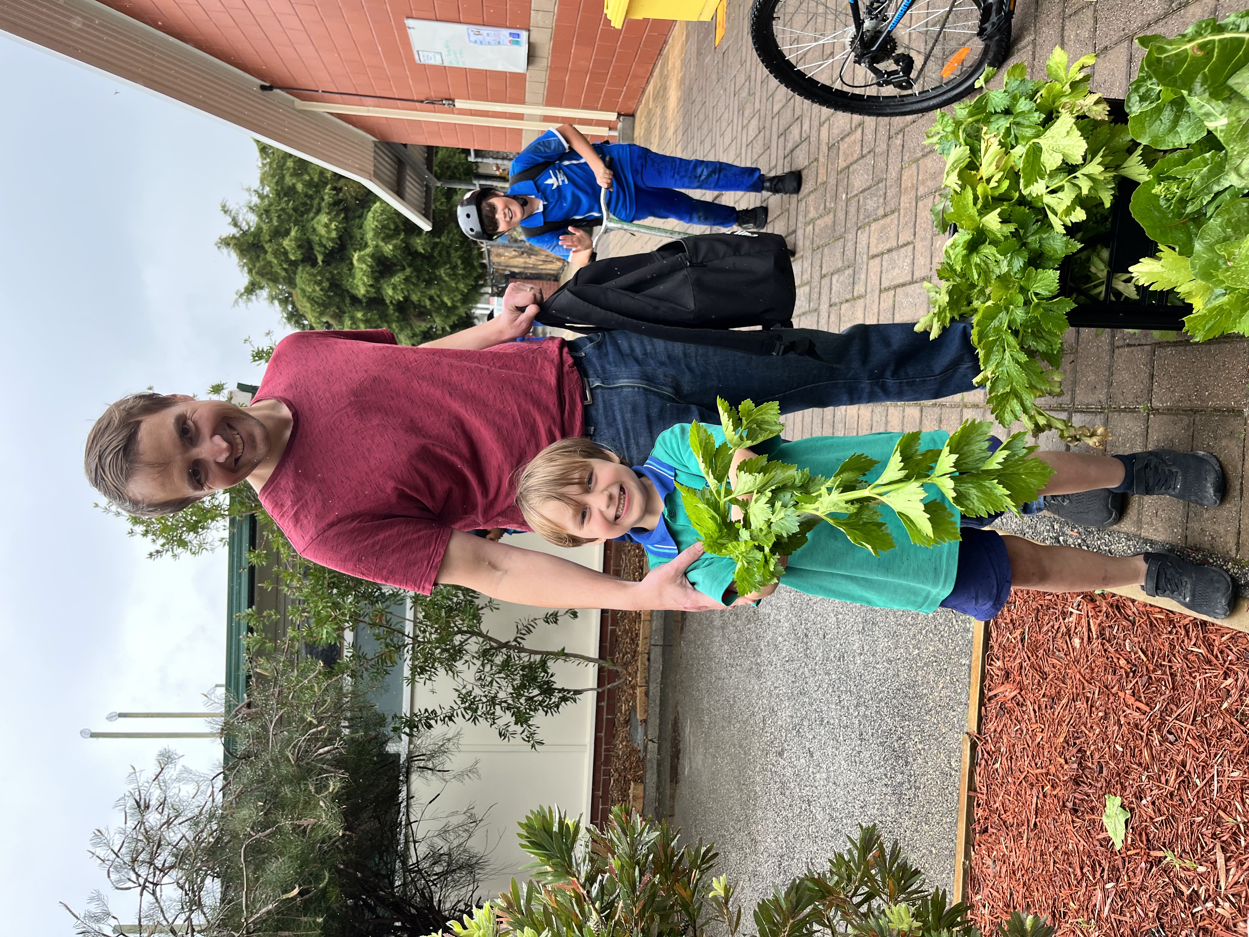 Parent and Student from Curtin Primary School collecting fresh produce from a Harvest Drop Off